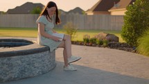 Girl Reading Bible Outside at Sunset