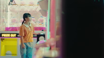 Little girl is playing games at the amusement park
