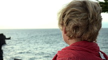Older woman looking out at the ocean.