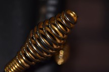 Golden coil handle on a wood stove
