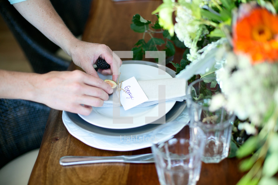 Woman making a colorful table setting 