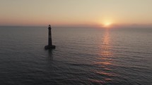 A lighthouse on the  Atlantic Ocean coast of South Carolina during sunrise 