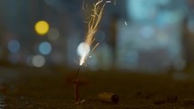 A firecracker is set on fire on a city street
