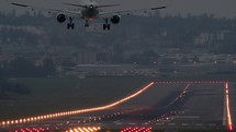 Airplane landing on a lit runway