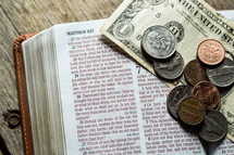 spare change on a Bible 