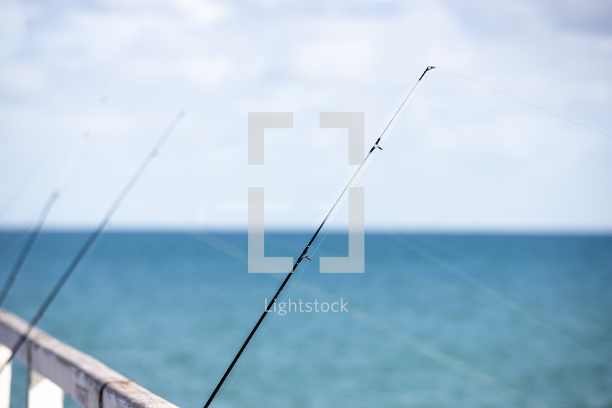 fishing poles on a pier 