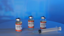 covid-19 vaccine vials and syringe 