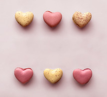 macaron cookies on a pink background for Valentine's Day 