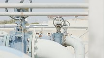 Oil and gas pipes and valves at a large oil refinery.