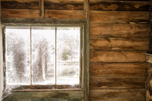 spider webs covering a cabin window 