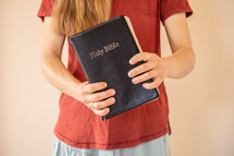 a girl holding a Holy Bible 