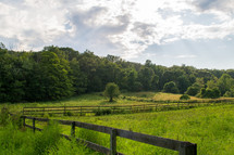 fence on green farmland 