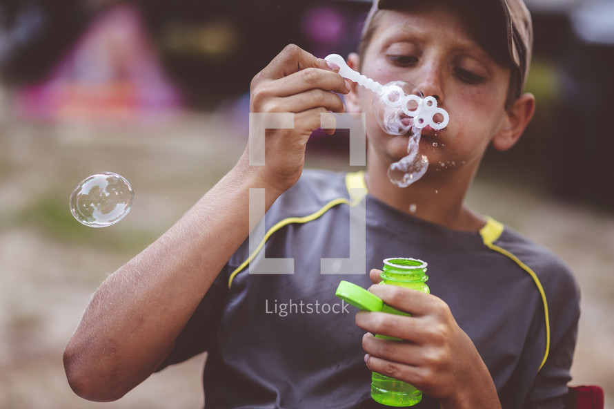child blowing bubbles 