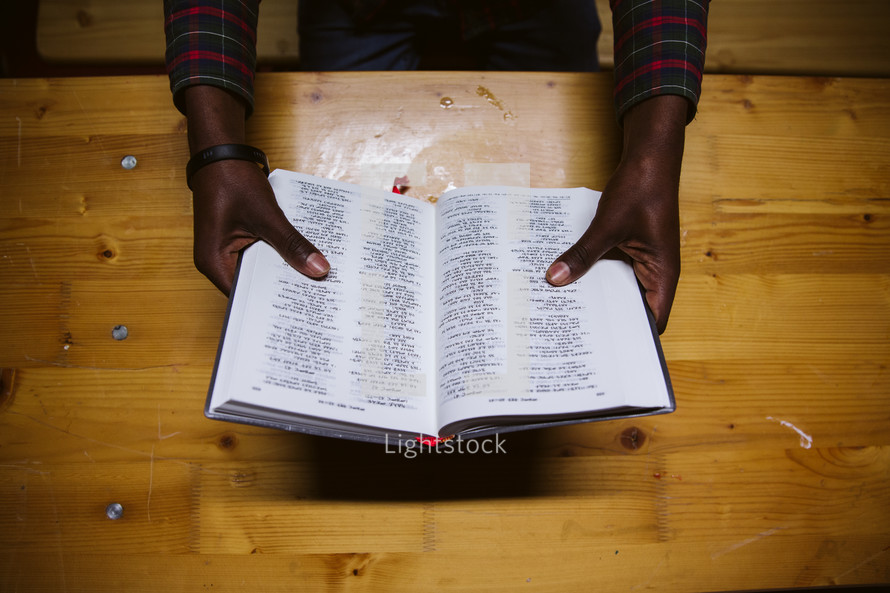 man holding open a German Bible