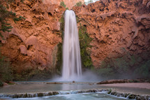 waterfall over red rock cliffs in Havasu falls Arizona 