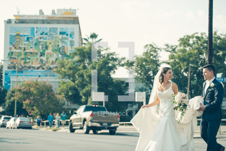 bride and groom crossing a street 