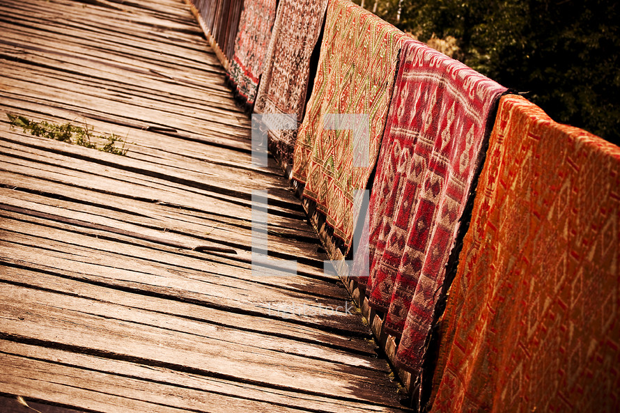 carpets drying on a bridge 