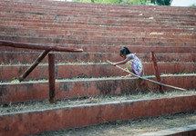 girl child playing with a stick in India 