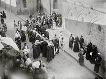 Pilgrims carrying a cross along the Via Dolorosa.
