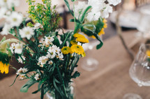 vase of yellow and white flowers 