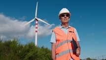 Senior engineer checks the operation of the new wind turbines in the mountains for the production of clean energy