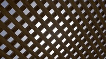 View to sky and sunshine through wooden net shed