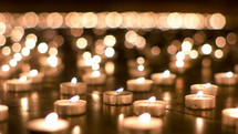 prayer votive candles in darkness 