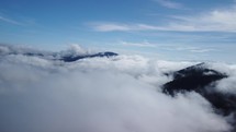 Beautiful cloudy landscape. Aerial view over clouds in hilly landscape, fluffy cloud