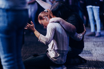 two women surrendering in prayer 