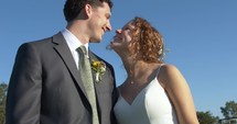 Happy couple, husband and wife, bride and groom kissing on wedding day.