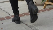 Young Girl Walks in Black Boots