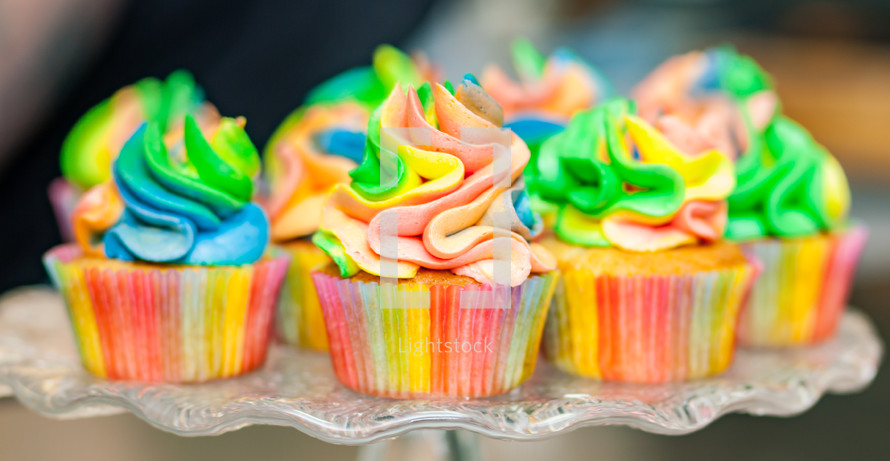 Colorful cupcakes with rainbow cream for Carnival