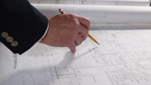 a man looking at blueprints 
