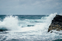 Ocean waves crashing onto a rocky shore.