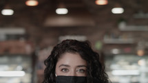 female at a cafe wearing a face mask 