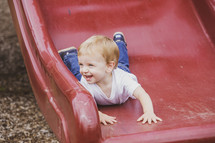 boy going down a slide 