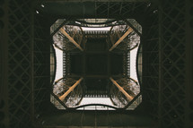 looking up through the center of the Eiffel tower 