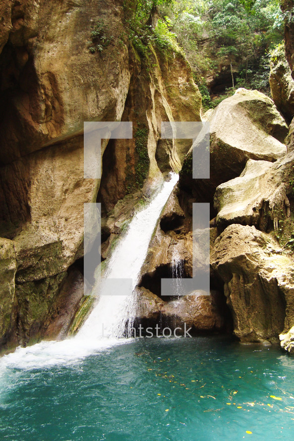 A waterfall feeding into a secluded pool