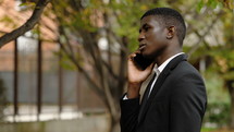 a businessman talking on a cellphone outdoors 