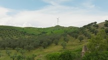 Wind power plant turbine generator on a green mountain