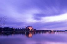 blurry image of homes by a lake 