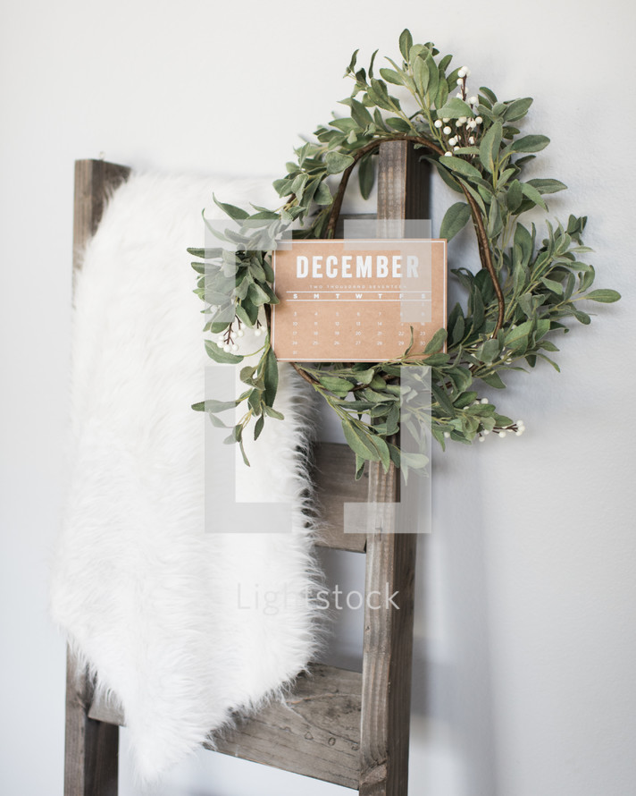 fur rug, ladder, and mistletoe wreath 