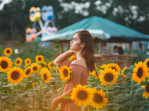 a teen girl in a field of sunflowers 