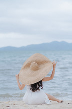 a woman in a large sunhat 
