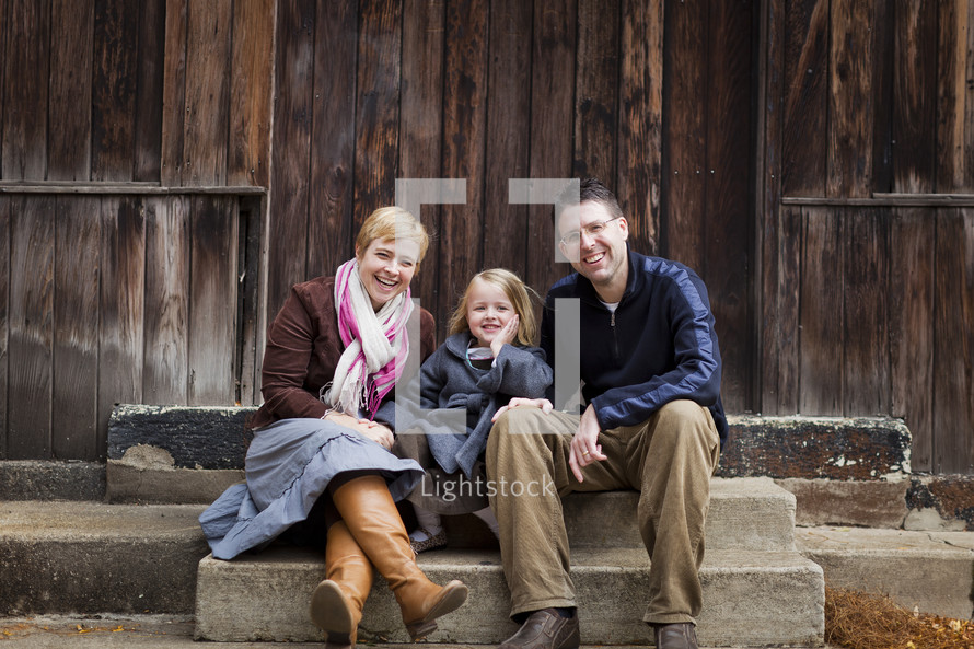 family sitting on stair steps 