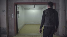 a man entering a warehouse elevator 