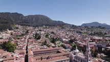 Aerial view backwards over the Santuario Nuestra Señora del Carmen, in sunny Bogota, Colombia