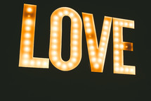 The word, "love," lit up in bright lights.