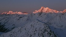 Dramatic cinematic drone circling over golden sunset on the Austrian Swiss Alps