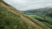 Aerial Drone View Of Green Fields And Hillside In Rural Wales